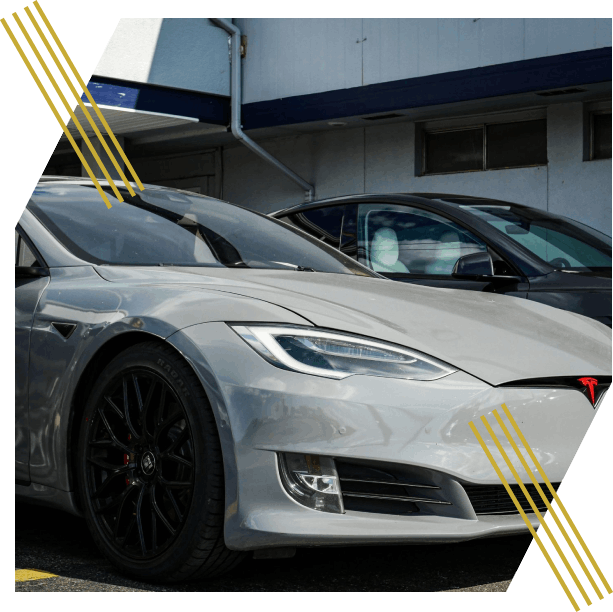 Close-up view of a sleek Tesla Model S parked outdoors, showcasing modern electric vehicle design.