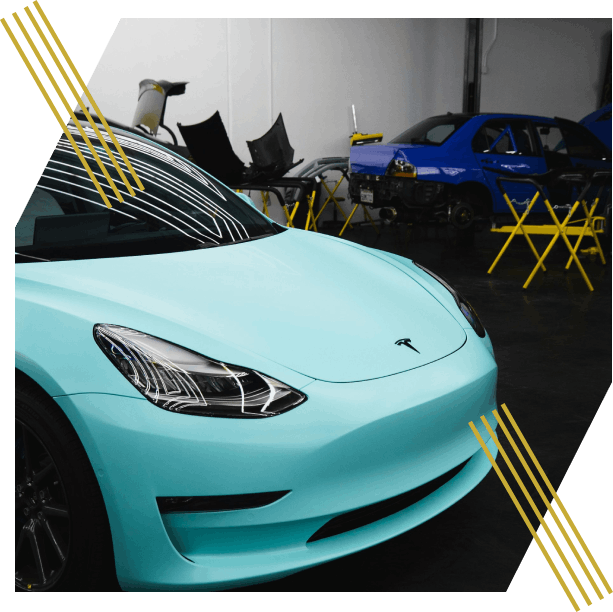 Aqua Tesla car in workshop