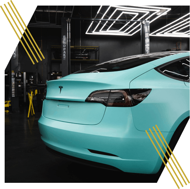 Turquoise Tesla in a garage