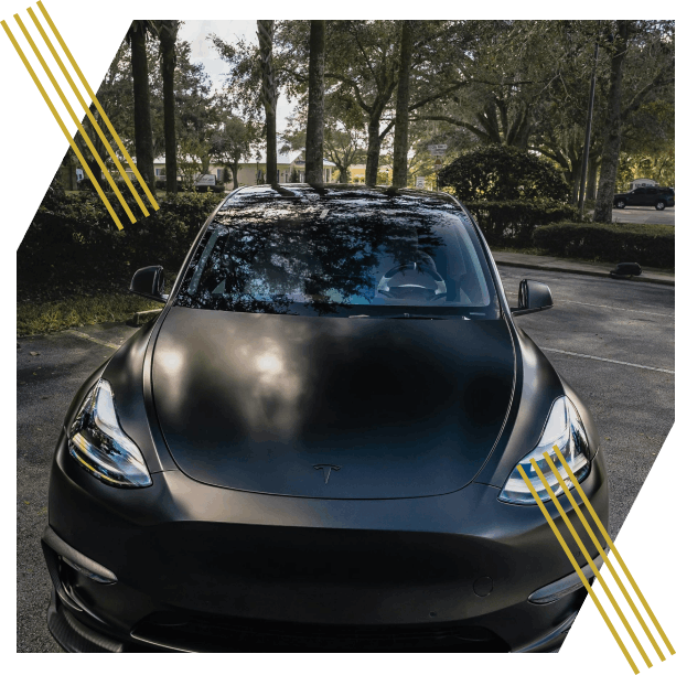 Black Tesla car in parking lot